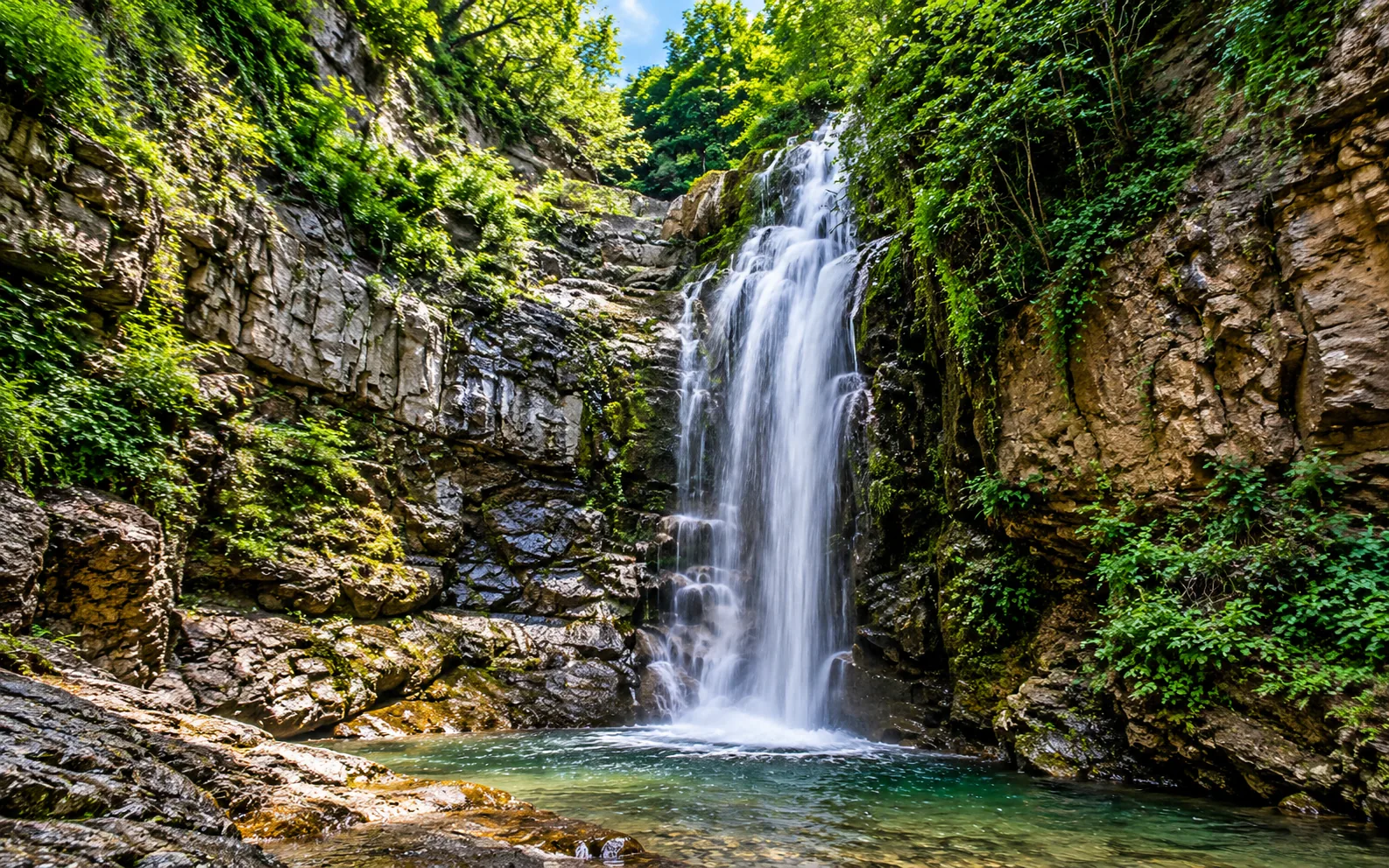 Leghvtakhevi Waterfall in Tbilisi surrounded by lush greenery