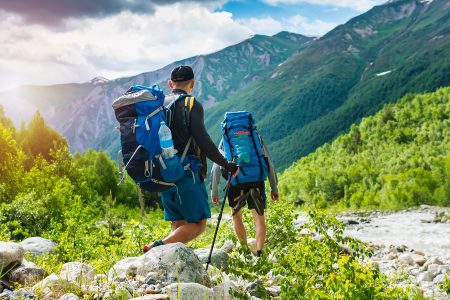 Tourists Trekking in mountains in wild nature with beautiful views in Svaneti, Georgia with EVANI Travel. 7 Days/6 Nights Tour Package in Georgia