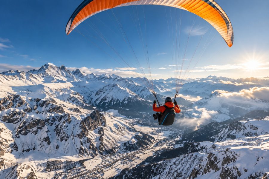 Paragliding above snow-covered Caucasus Mountains near Gudauri Georgia