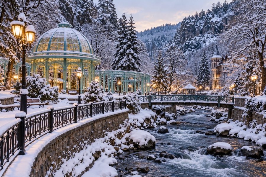 Snow-covered Borjomi Central Park with river and glass pavilion